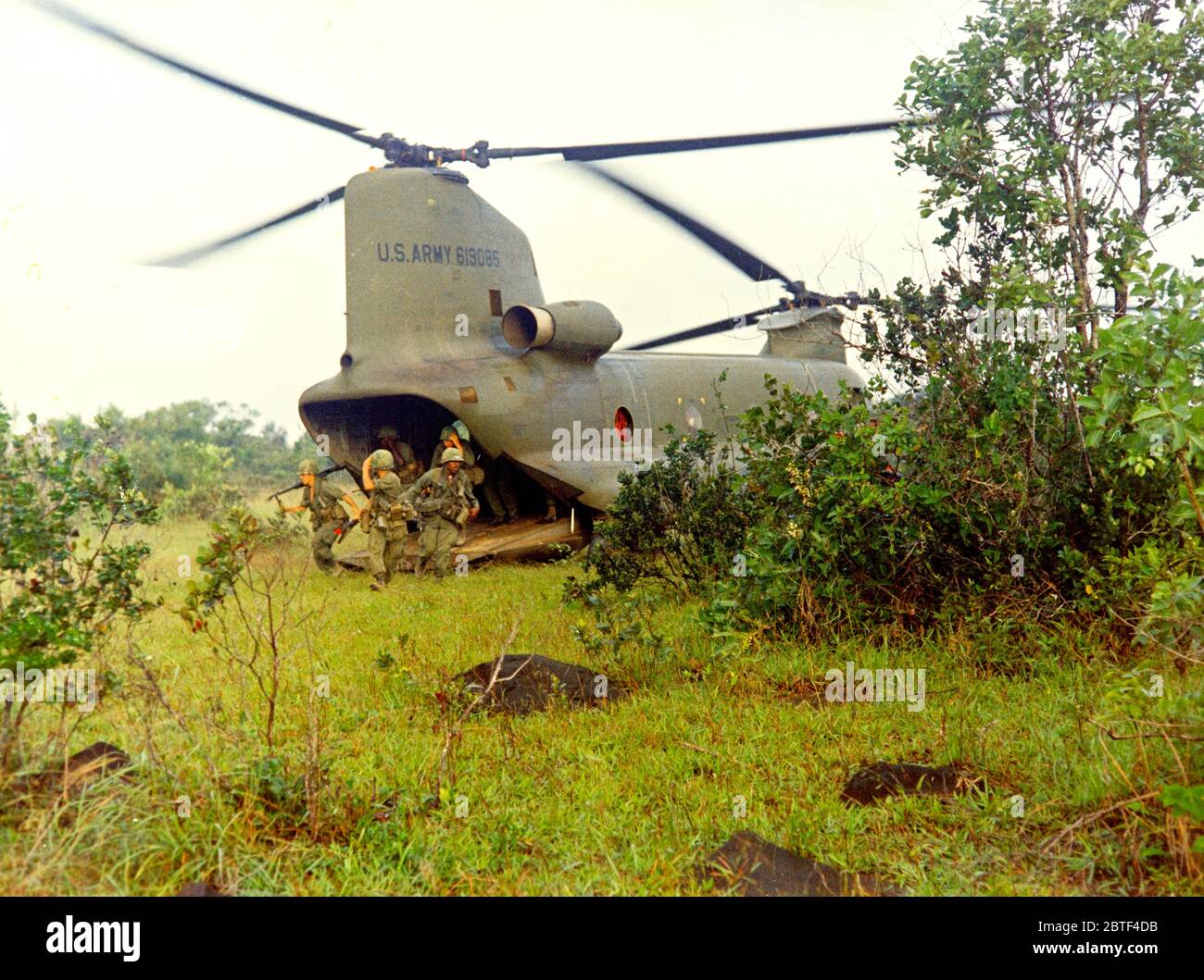 Vietnam Krieg Foto - Mitglieder der Co D, 2 Mrd. Euro, 35th Inf, 3 Bde, 4. inf Div, aus einer CH-47A Chinook Hubschrauber bei der Landung Zone ein Hubschrauber bekämpfen Angriff 10 26 1967 zu entladen Stockfoto