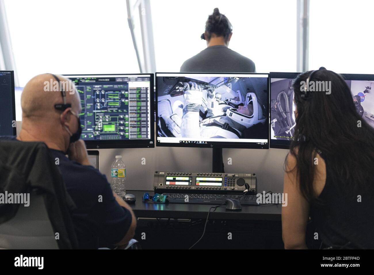 Die NASA-Astronauten Robert Behnken, Hintergrund, und Douglas Hurley, im Vordergrund, werden auf einem Monitor gesehen, der in der Kapsel Crew Dragon beim Launch Complex 39A während einer Generalprobe zur Vorbereitung des Starts einer SpaceX Falcon 9 Rakete, die das Raumschiff Crew Dragon auf der NASA-Mission SpaceX Demo-2 trägt, Am 23. Mai 2020, im Feuerraum vier des Launch Control Center am Kennedy Space Center der NASA in Florida. Quelle: UPI/Alamy Live News Stockfoto