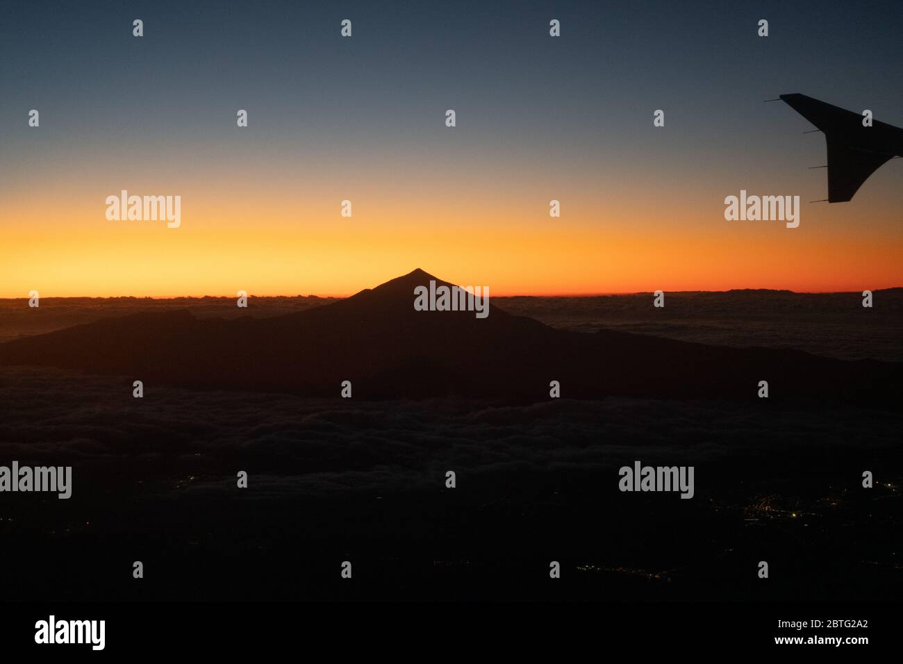 Blick auf den Teide Vulkan Gipfel über Wolken bei Sonnenuntergang, höchster Gipfel in Spanien 3718 m über dem Meeresspiegel Eroplane während Flug bei Sonnenuntergang Stockfoto
