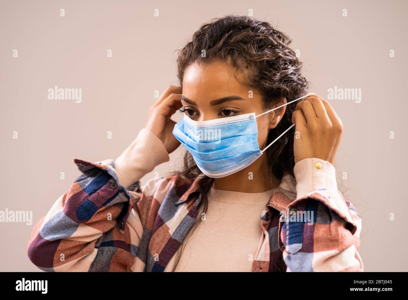 Studio-Aufnahme Porträt der schönen afroamerikanischen Ethnizität Frau, die Schutzmaske setzt. Stockfoto