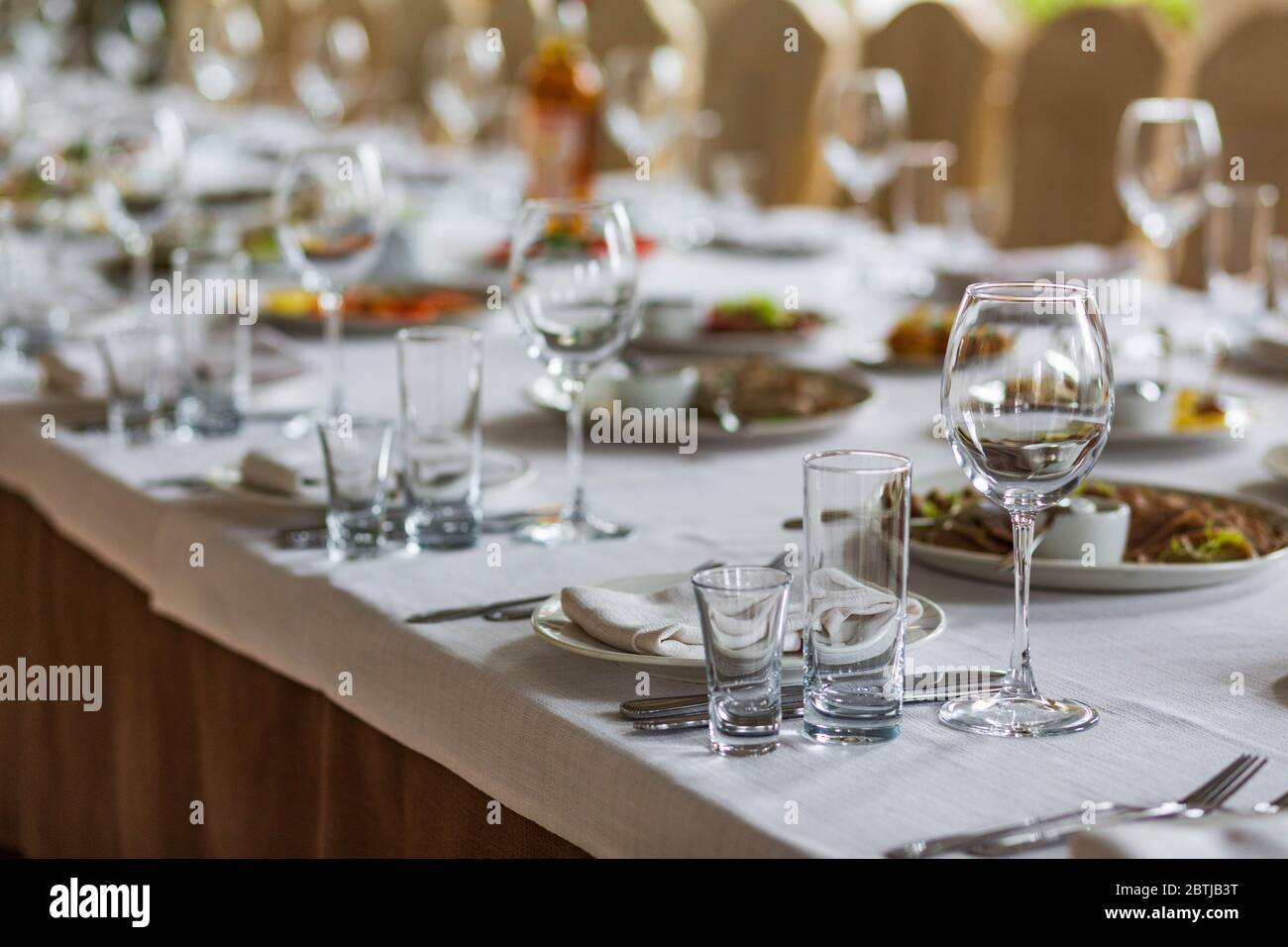 Gläser auf dem Tisch zum Abendessen im gemütlichen Restaurant serviert Stockfoto