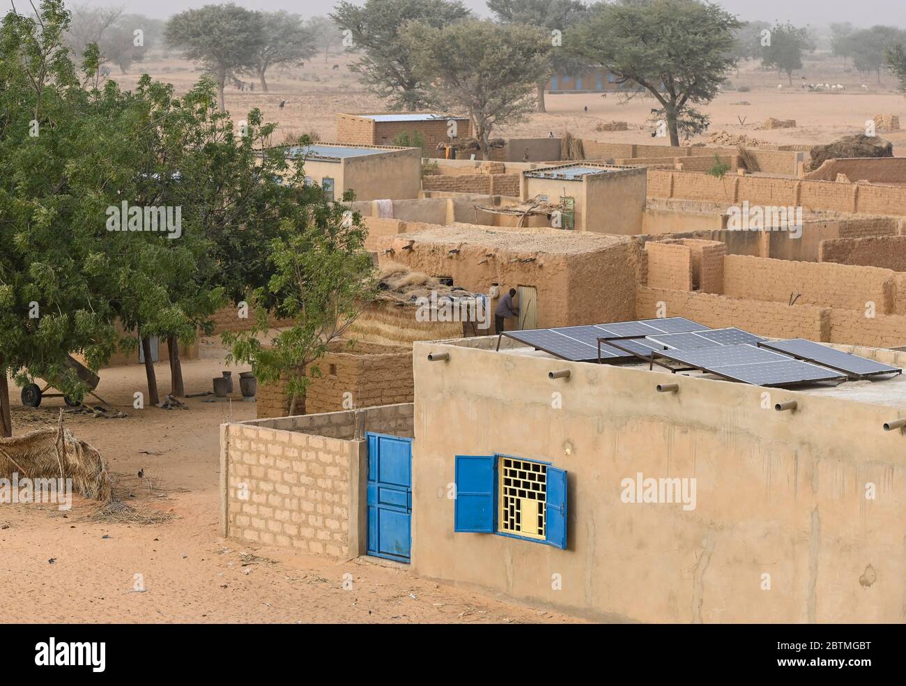 NIGER, Maradi, Dorf Dan Bako, Lehmhäuser und Zementbau mit Photovoltaik-Solaranlage / Haus aus Lehm und Zement mit Solar Home System Stockfoto
