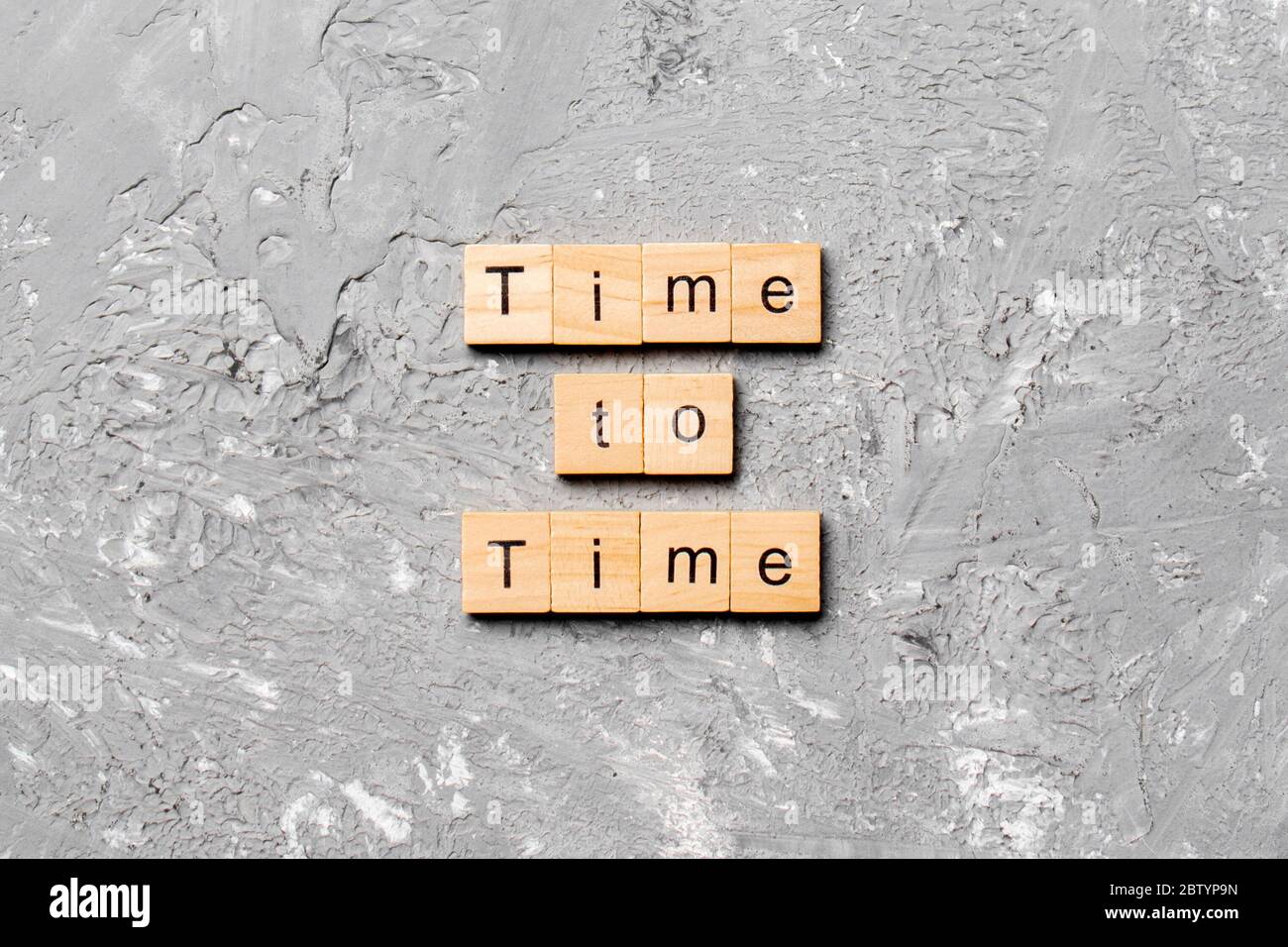 Zeit zu Zeit Wort auf Holzblock geschrieben. Zeit zu Zeit Text auf Zementtisch für Ihre Desing, Konzept. Stockfoto