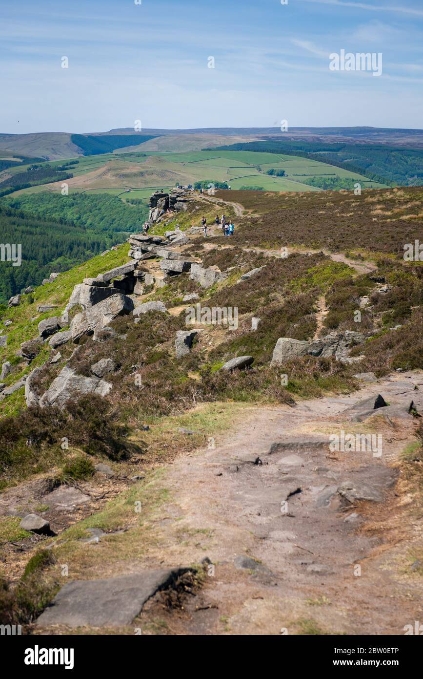 Blick von Bamford Edge in Richtung Ladybower Reservoir mit Menschen sitzen / klettern / genießen den Tag nach der Sperrung Coronavirus erleichtert wurde Stockfoto