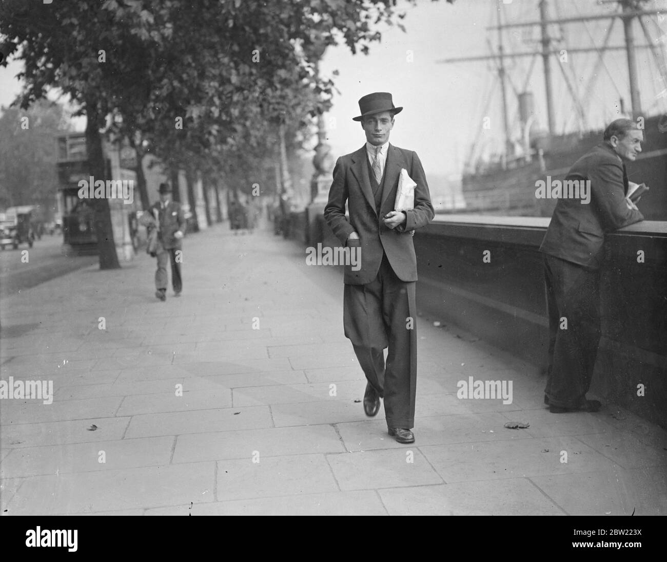 Philip Knowling blickt bei seiner Ankunft in London vom Damm aus über die Themse. Der Schwiegersohn von Lloyd George und Neffe des Chirurgen Sir Thomas Carey-Evans ist nach einer Weltumrundung als Kohlentrimmer, Robbenfischer und Stevedore in London angekommen. Gedrängt vom Wunsch, die Bedingungen in Russland für sich selbst zu sehen, ging er von Toronto nach Hull, fuhr nach London und schaffte es, eine Passage nach Russland zu bekommen. Von dort aus besuchte er Hashed, die Heilige Stadt der Perser, und ging weiter nach Indien und Burma, wo er in Klöstern schlief. Er fuhr durch Burma nach Siam und ging durch nach Stockfoto