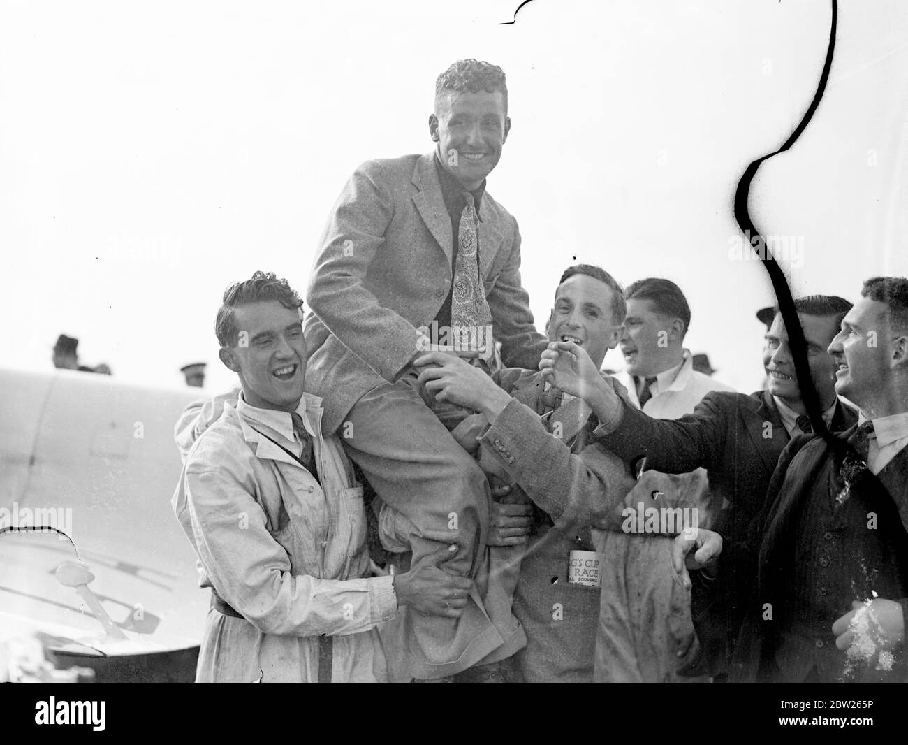 Henshaw erhält Trophäe von Air Minister nach dem Gewinn des King's Cup Race. Alex Henshaw, der in den ersten zehn Runden 236 Meilen pro Stunde zurückgelegt hatte, gewann das King's Cup Air Race in seinem Percival New Gul Flugzeug und erhielt die Trophäe von Sir Kingsley Wood, dem Air Minister. Die Strecke war über 1,000 Meilen, Start und Ziel in Hatfield. Foto zeigt, dass Alex Henshaw nach seinem Sieg den Vorsitz in Hatfield innehatte. Juli 1938 Stockfoto