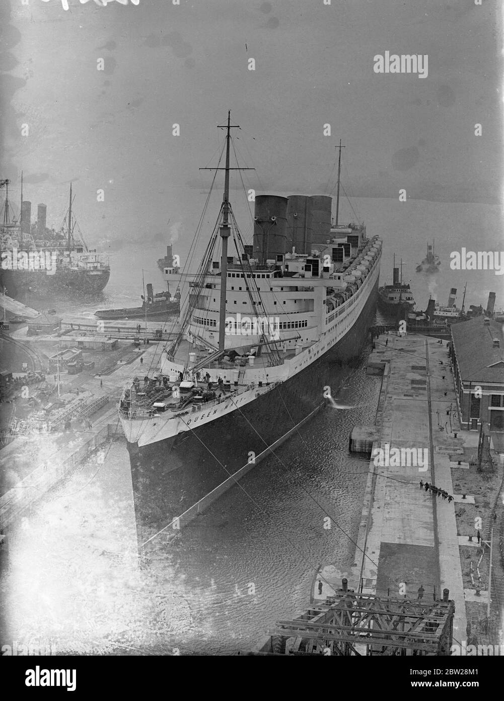 'RMS Queen Mary' betritt zur Überholung das Trockendock. Neuer Rekordversuch im Atlantik?. Nach ihrem zweiten erfolgreichen Jahr, Service, der Riesendliner 'Queen Mary', als in den King George V, Grading Dock in Southampton für ihre jährliche Überholung. Sie wird bis zum 2. Februar liegen, und es wird erwartet, dass ein neuer Versuch auf dem Atlantischen Blauen Band gemacht wird. Foto zeigt, die 'Queen Mary', die zur Renovierung in das King George V Trockendock in Southampton eindringt. 29 Dezember 1937 Stockfoto