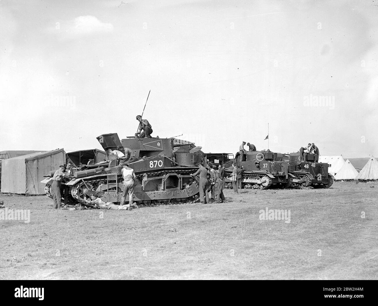 Ein Vickers Medium Mk III und zwei Vickers Medium Mk II (rechts) der 1. Panzerbrigade auf der Salisbury Plain, die auf dem Feld gewartet werden. Bis 20. August 1935 Stockfoto