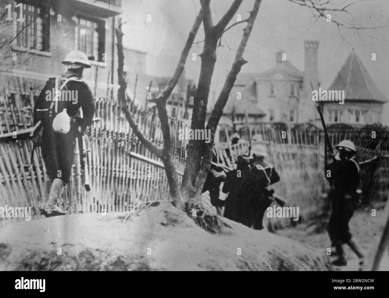 Japanische Marineinfanteristen jagen chinesische Scharfschützen. Japanische Marineinfanteristen jagen chinesische Scharfschützen am Rande der Internationalen Siedlung in Shanghai. 26. Februar 1932 30er, 30er, 30er, 30er, 30er, 30er Jahre Stockfoto