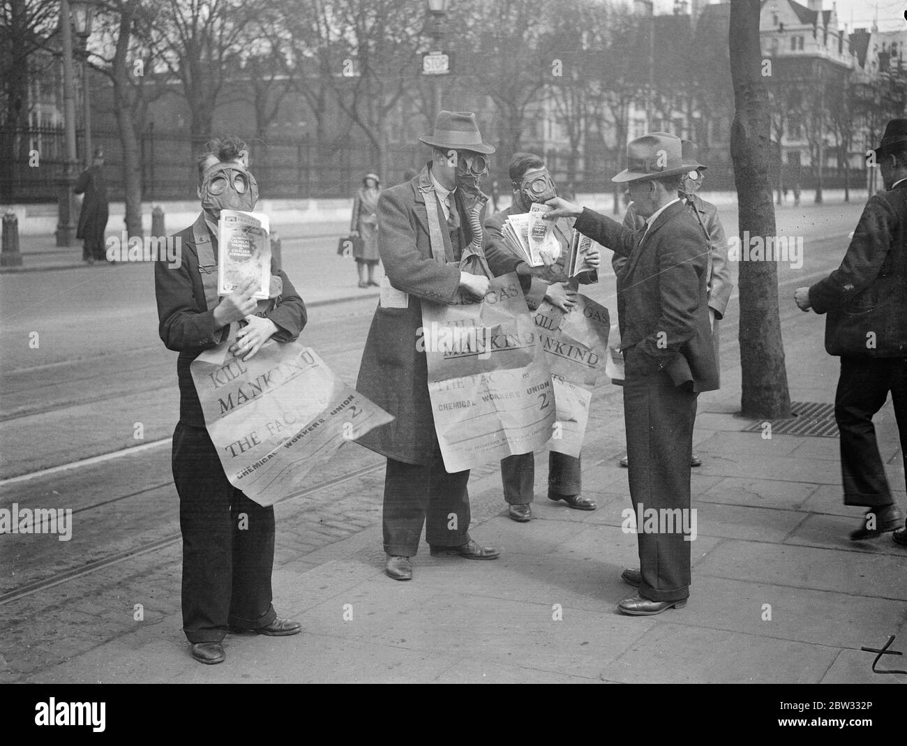 Gasmaskierte Demonstranten veranstalten die Maiparade in London. Demonstranten tragen Gasmasken und traryingplakate drängen auf die Abschaffung der Gas-und chemischen Krieg, leitete die Maifest Parade durch London, die von der Uferstraße begann. Demonstranten weraing Gasmasken marschieren entlang der Embankment, London bei der Demonstration am 1. Mai. 29. April 1932 Stockfoto