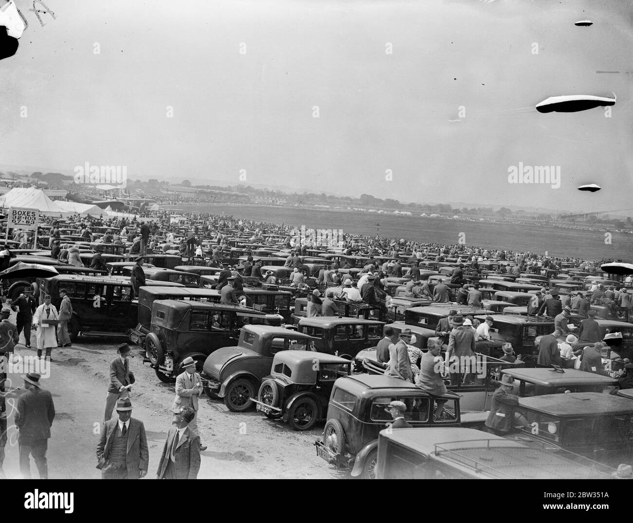 Autos als Tribünen bei Hendon Air Pageant. Tausende nutzten ihre Autos als Tribünen, um die wunderbare Ausstellung akrobatischer Flugreisen der Royal Air Force auf der Hendon Air Pageant am Hendon Aerodrome zu beobachten. Tausende beobachten den Festzug von ihren Autos in Hendon. 25 Juni 1932 Stockfoto