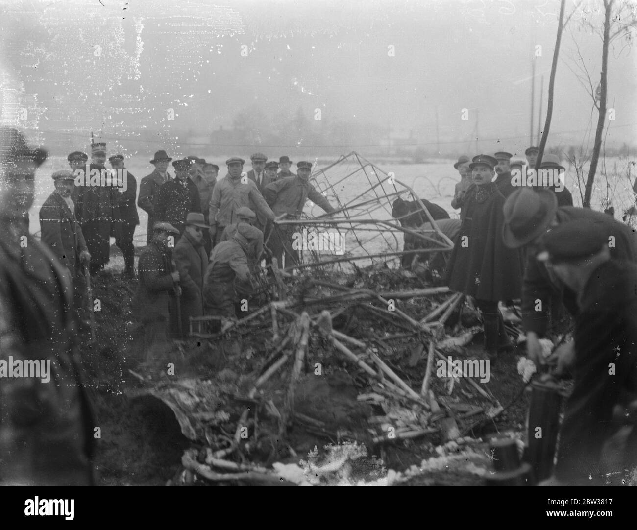 Zehn bei einem britischen Verkehrsflugzeug-Crash getötet. Acht Passagiere, der Pilot und der erste Offizier wurden getötet, als das Imperial Airways-Flugzeug, Apollo, von Brüssel nach London flog, in den Antennenmast des Ruysselde-Radiosenders in der Nähe von Brügge, Belgien stürzte und in Flammen aufbrach. Foto zeigt ; das Wrack des Flugzeugs und einer der vergrabenen Motoren nach dem Absturz . 31 Dezember 1933 Stockfoto