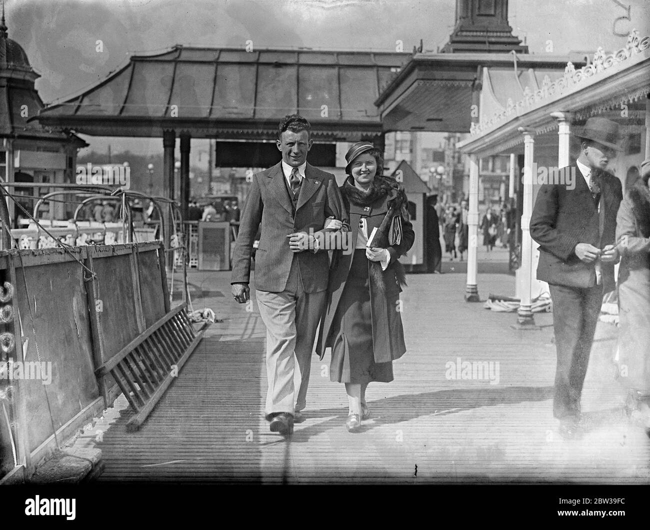 Kapitän des Manchester City Football Club, Sam Cowan, der mit seiner Frau am Brighton Pier entlang läuft. April 1934 Stockfoto