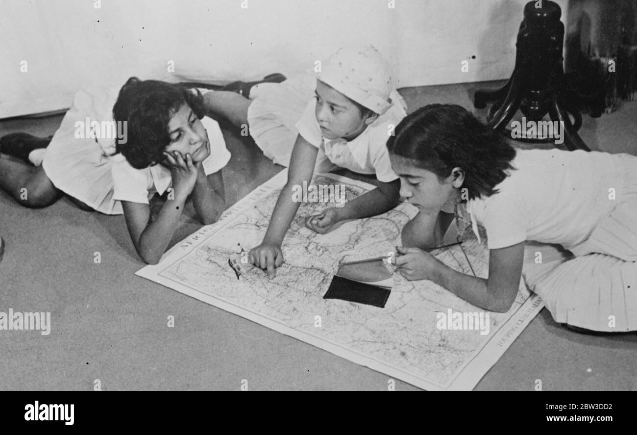 Auch die Kinder haben das Kriegsfieber. Bei ihrem Haus in Rom, auf einer großen Karte von Ostafrika, diskutieren drei kleine Mädchen scharf über die italienische Kampagne in Abessinien und verfolgen den Weg des Vorrückens in Makale. November 1935 Stockfoto