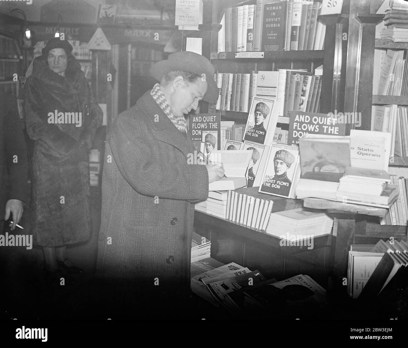 Michail Sholokhov, russischer Bestseller-Autor, bei seinem ersten Besuch in London. Foto zeigt; Michail Sholokhov Unterzeichnung seines Buches. Januar 1935 Stockfoto