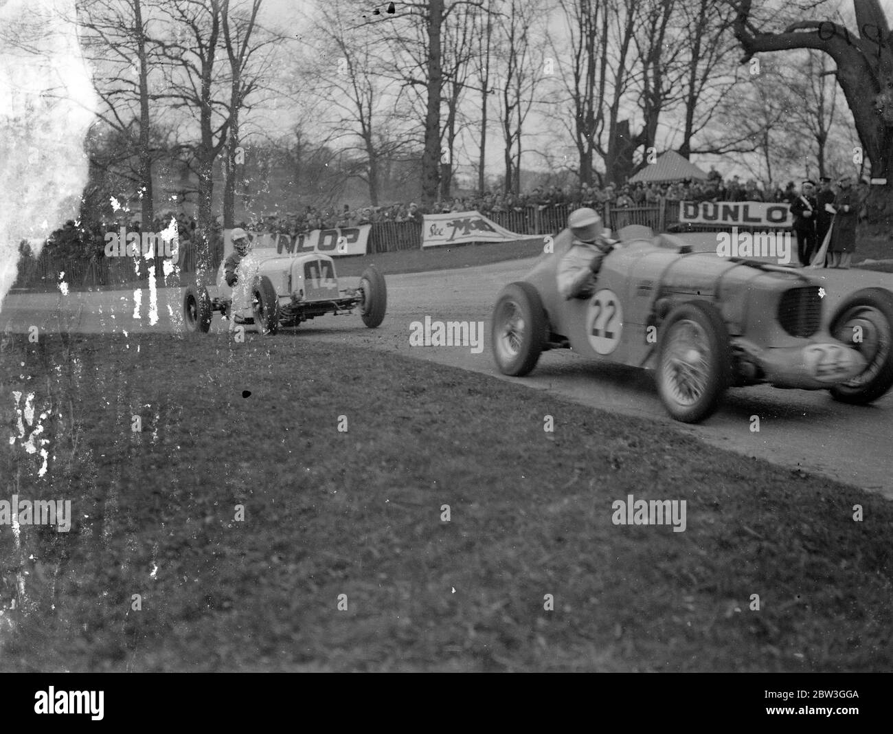 Seemann gewinnt erste große Straße Rennen der Saison Durchschnitt 66 . 33 mph. Fahren seine Maserati mit einer Durchschnittsgeschwindigkeit von 66 .33 Meilen pro Stunde, RJB Seaman der British Empire Trophy Race, British erste klassische Straßenrennen der Saison in Donington Park, in der Nähe von Derby. P G Fairfield ( E R A ) wurde Zweiter und D G Everitt ( Alfa Romeo ) Dritter. 27 der größten Rennfahrer Großbritanniens traten an und zwanzigtausend Zuschauer sahen das Rennen. Foto zeigt, R Parnell in MG (Nr. 22), P G Fairfield in der E R A (Nr. 14) an der Haarnadel. April 1936 Stockfoto