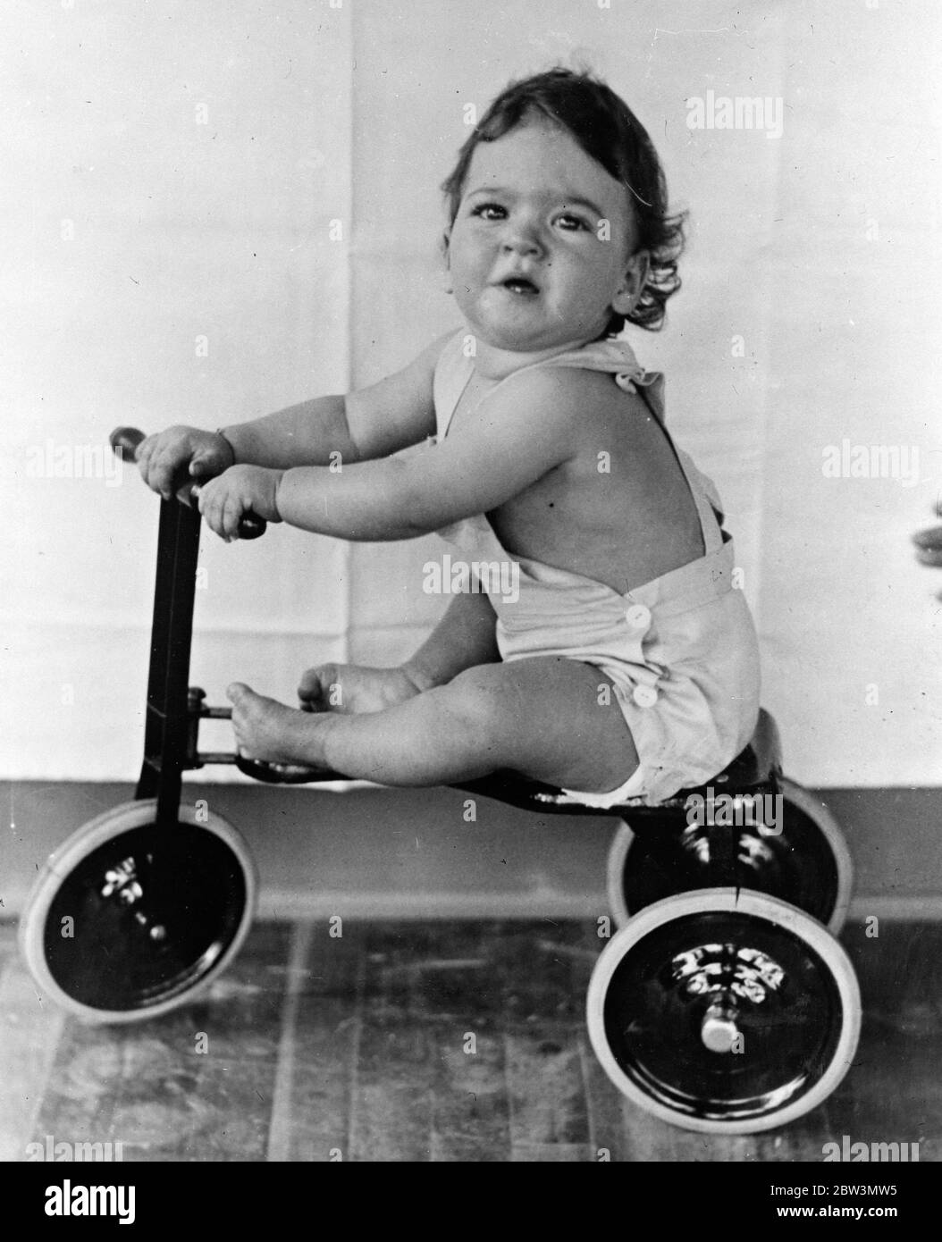 Die Sänften sind Geschwindigkeitsfienten! . Jemand gab ihnen ein Dreirad. Der Reiz der Geschwindigkeit hat nun die Dionne Quintlets in der Ruhe ihrer Kinderstube in Callender, Ontario ergriffen. Einige gut Bedeutung Bewunderer gab ihnen eine Tricycyle und es dauerte nicht sehr lange, um die Babys zu entdecken, seine Möglichkeiten ! . Foto zeigt, Yvonne zieht ihre molligen Beine auf den Sitz des Dreirads und appelliert an einen guten herzhaften Schub. 24. November 1935 Stockfoto
