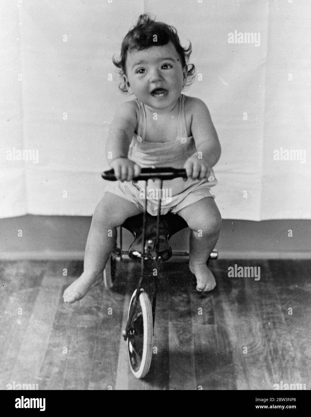 Die Sänften sind Geschwindigkeitsfienten! . Jemand gab ihnen ein Dreirad. Der Reiz der Geschwindigkeit hat nun die Dionne Quintlets in der Ruhe ihrer Kinderstube in Callender, Ontario ergriffen. Einige gut Bedeutung Bewunderer gab ihnen eine Tricycyle und es dauerte nicht sehr lange, um die Babys zu entdecken, seine Möglichkeiten ! . Foto zeigt, Annette lacht mit Freude, als sie auf dem neuen Dreirad um die Kinderstube rast. . 24. November 1935 Stockfoto