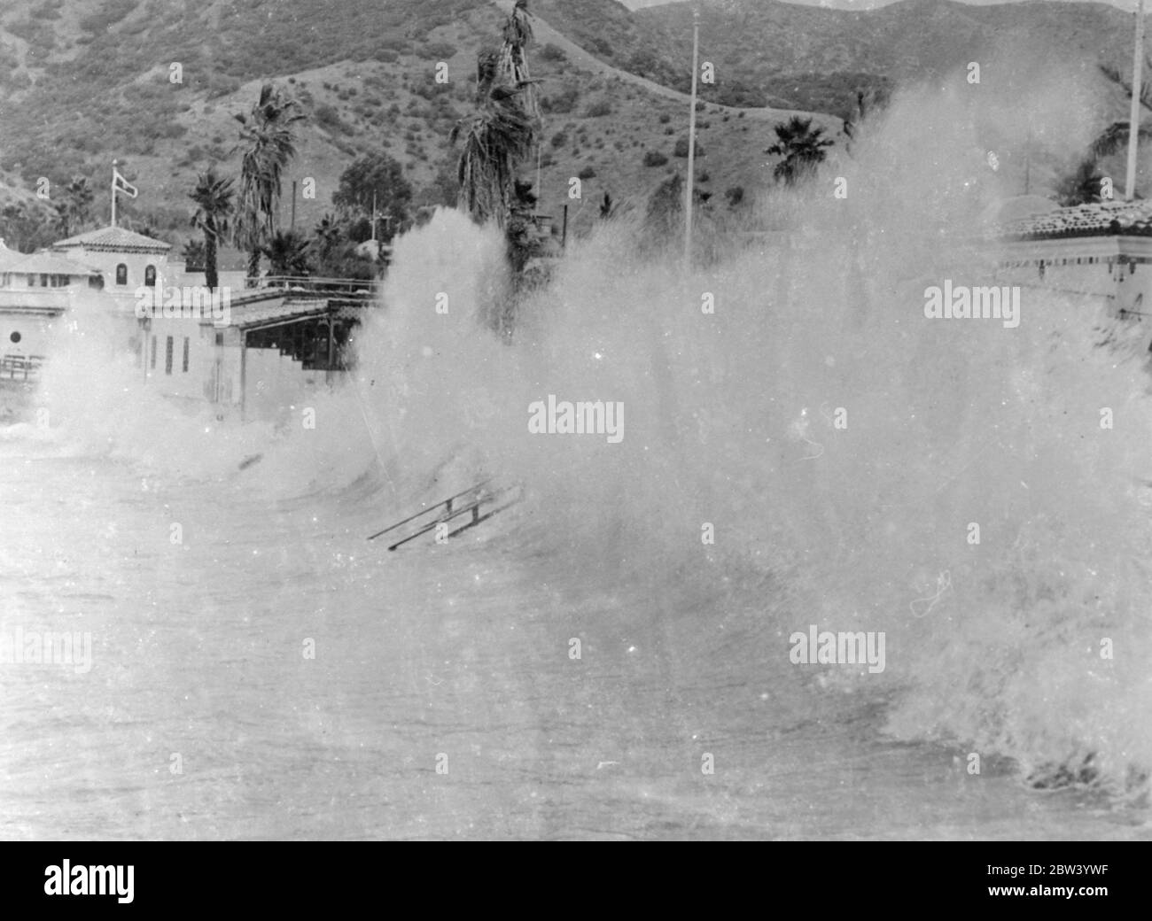 Racing sieht Pfund kalifornischen Resort in einem tollen Sturm. Das normalerweise ruhige westliche von Avalon Bay auf Santa Catalina Island, Kalifornien, wo in brüllende Berge von Schaum durch 50 Meilen pro Stunde Sturm aus Nordosten gepeitscht. Die berühmte Promenade und die Gebäude entlang der Uferpromenade des Resorts wurden von den tosenden Meeren geknallt. Foto zeigt: Die gewaltigen Wellen brechen über die Front in Avalon Bay. 11 Dezember 1936 Stockfoto