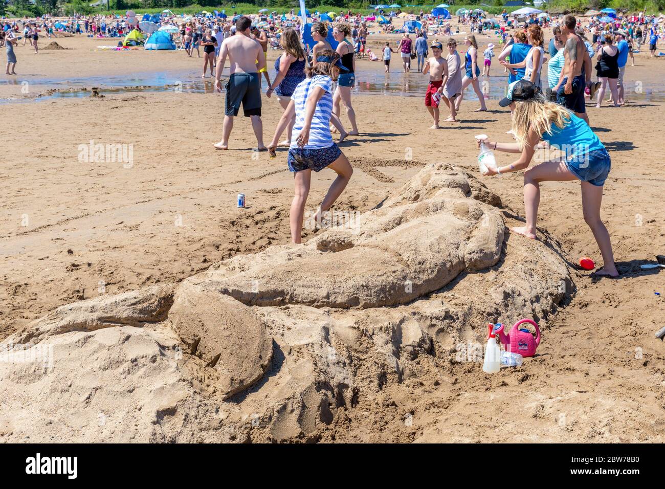 New River Beach, New Brunswick, Kanada - 7. Juli 2018: Der jährliche Wettbewerb für Sandskulpturen. Zwei Frauen arbeiten an einer Meerjungfrau-Skulptur. Stockfoto