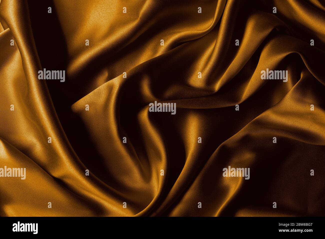 Goldene Seide Nahaufnahme Textur Hintergrund. Stockfoto