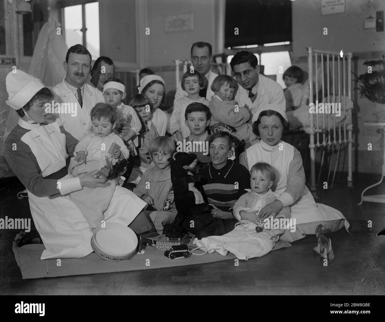 Die Königin 's weihnachtsspielzeuge für Kinder in Queen Mary 's Hospital . Die Königin hat ein Geschenk von Spielzeug an die Kinder im Queen Mary 's Hospital für das East End, Stratford, E15 geschickt. Einige der Ärzte, Krankenschwestern und Kinder, mit dem Royal Toys. 20 Dezember 1933 Stockfoto