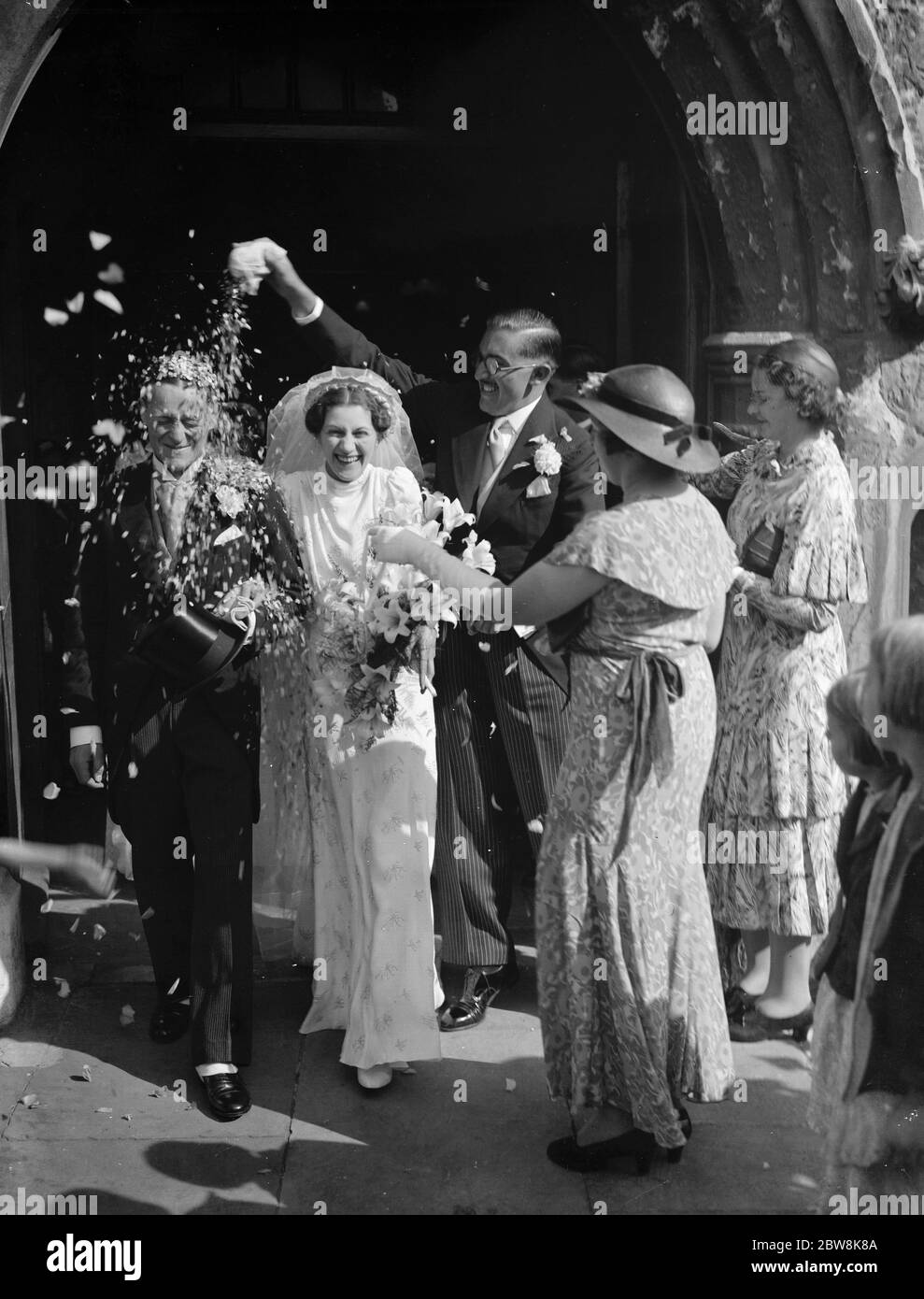 Potts und Burgess Hochzeit . Das glückliche Paar wird mit Konfetti geduscht. 1937 Stockfoto