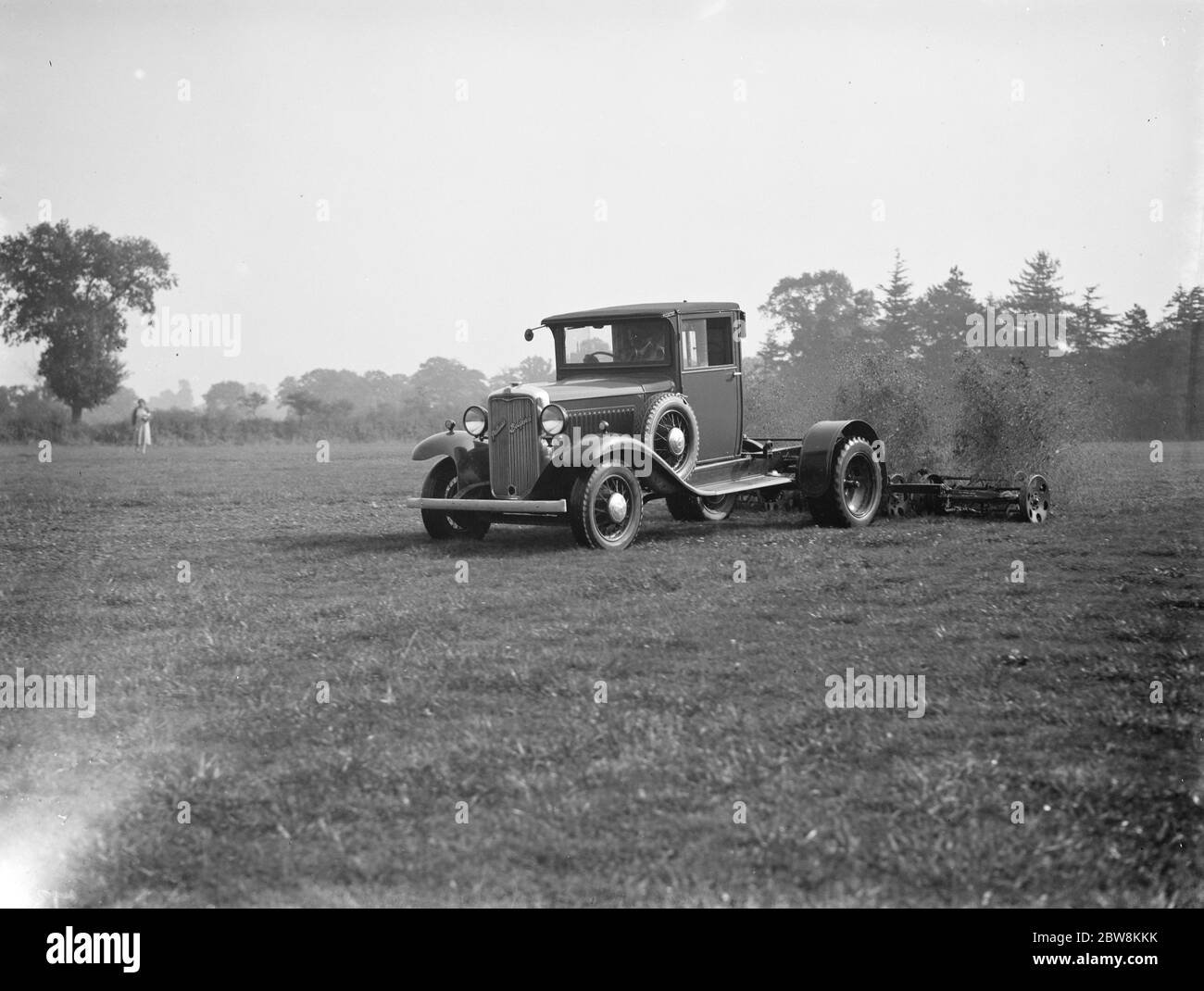 Mähen Sie das Gras mit dem Mäher an der Rückseite eines LKW geheckt. 1937 Stockfoto