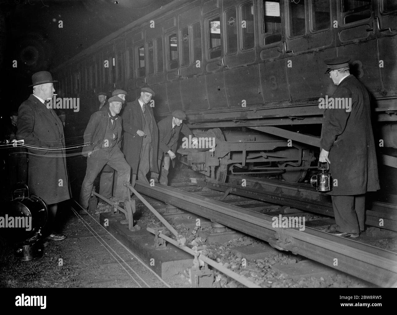 Ingenieure sehen sich die Schäden an einem entgleisten Zug Wagen in Well Hall, Eltham. 1935 Stockfoto