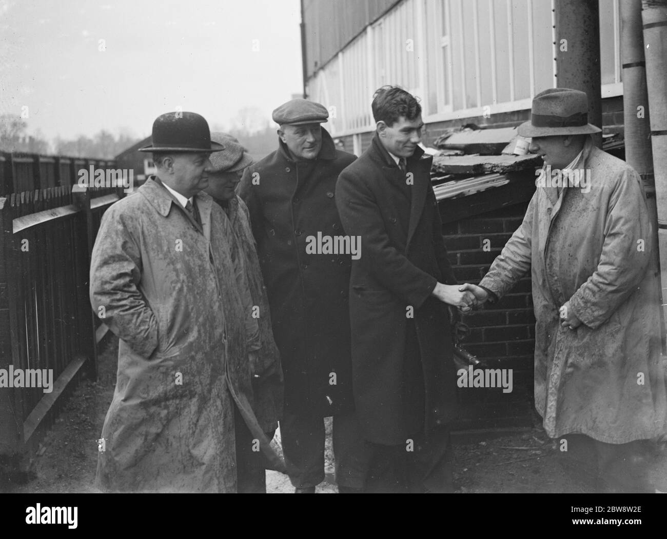 Star-Spieler Fred Dell von Dartford Football Club schüttelt die Hände mit Manager, Bill Collier vor den Tribünen. 1936 Stockfoto