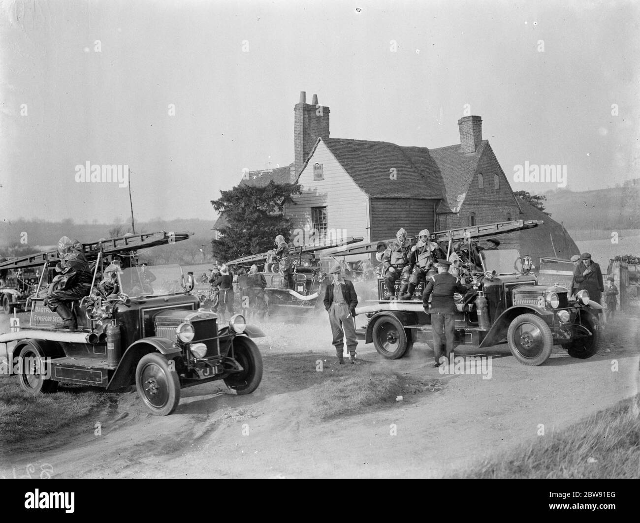 ARP (Luftangriffsvorkehrungen) Demonstrationen. Feuerwehrleute Ankunft in Green Street Green in Schutzkleidung und Gasmasken. März 1938 Stockfoto