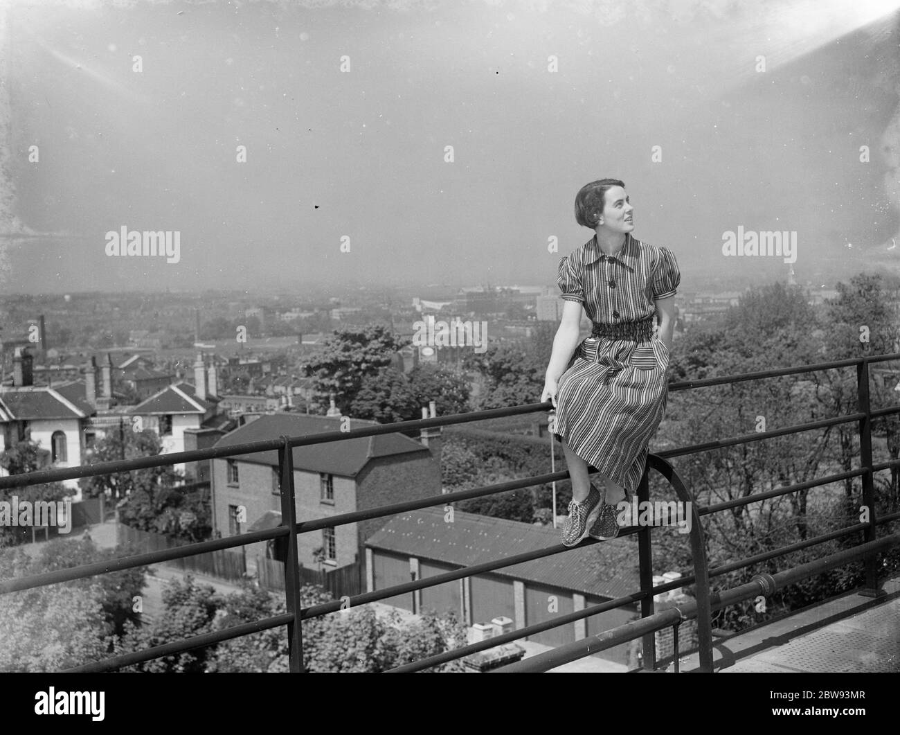 Die Aussicht vom Lewisham Krankenschwestern' Hausdach. Eine Frau posiert auf einer Schiene. 1939 . Stockfoto
