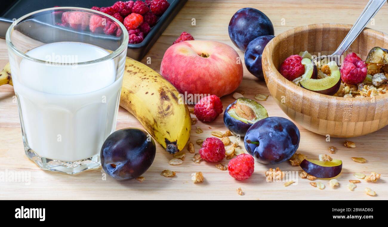 Kinder-Frühstückskübel mit Müsli, Beeren, Obst und Milch Stockfoto