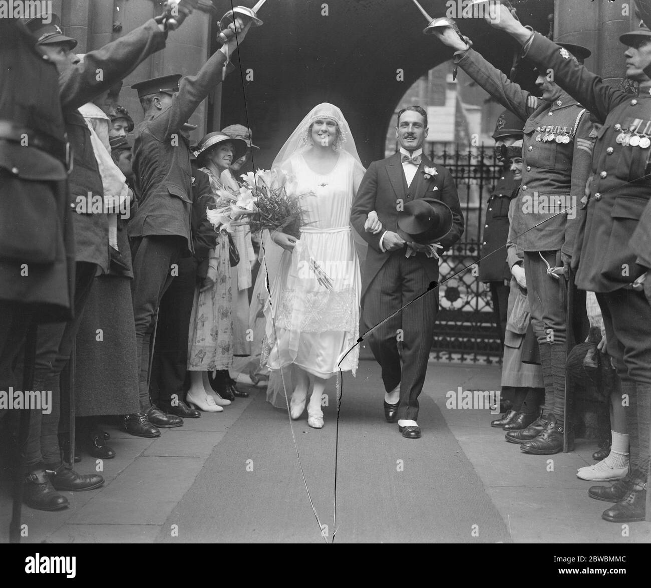Draggon Guards Officer Weds Mr. K B Stanley 4. Royal Irish Dragoon Guards und Miss A C Watkins wurden in der St. Mary Abbots Church , Kensington an diesem Nachmittag das glückliche Paar unter einem Bogen von Schwertern, die von einem Dragoon Wachen nach der Zeremonie 25 August 1921 gebildet verheiratet Stockfoto
