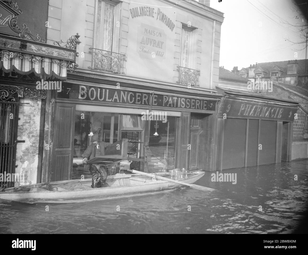 Paris und seine Vororte unter Wasser. Ein Bäcker, der seine Waren aus seinem Laden herausnahm, der bei Choisy le ROI überschwemmt wurde. Januar 1924 Stockfoto