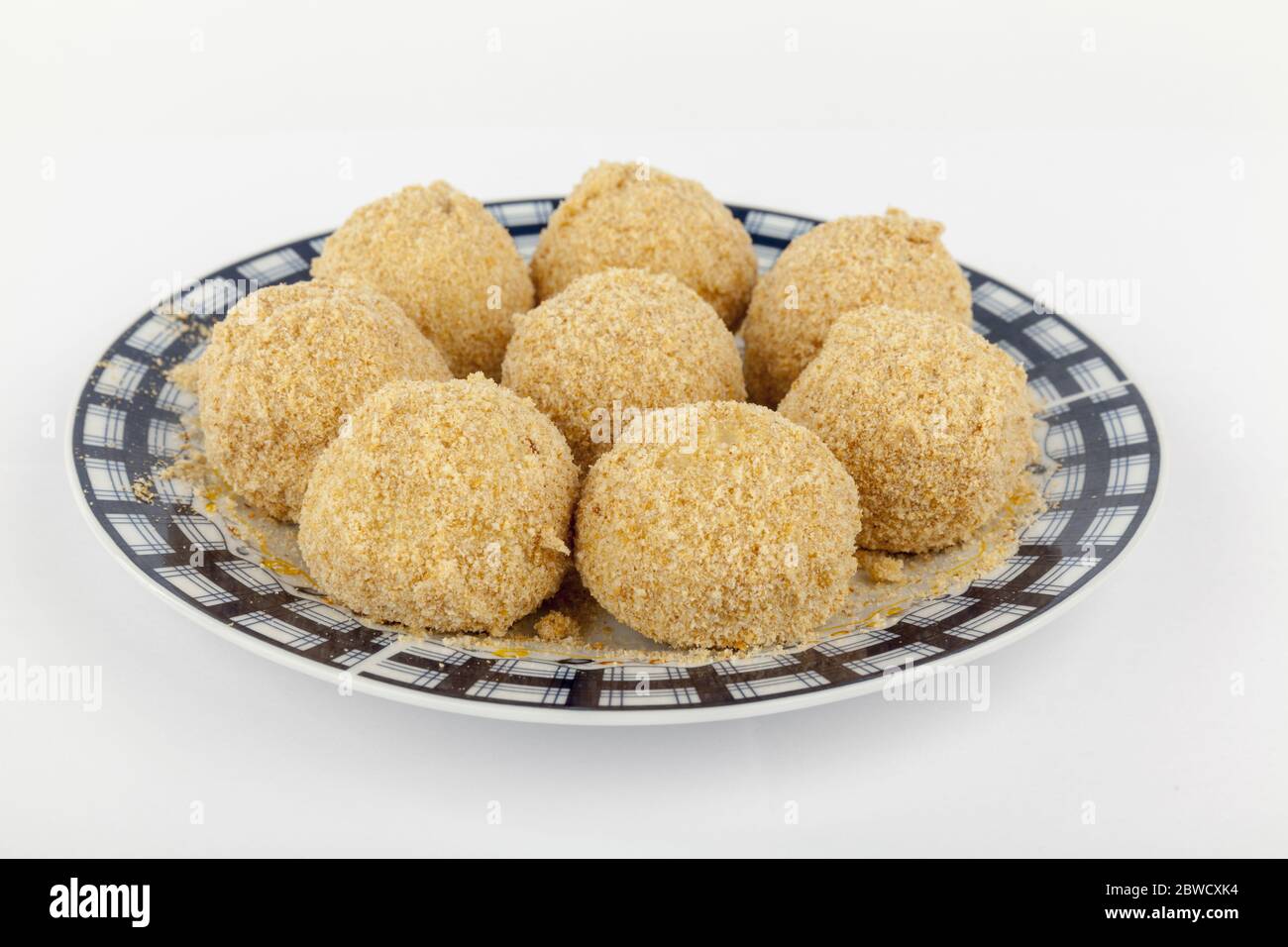 Knödel mit Pflaumen auf einem Teller, isoliert auf weiß Stockfoto