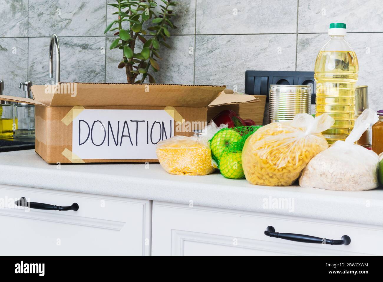 Öffnen Sie eine leere Spendenbox mit Lebensmitteln in der Küche. Hilfe für Menschen. Wohltätigkeitskonzept Stockfoto