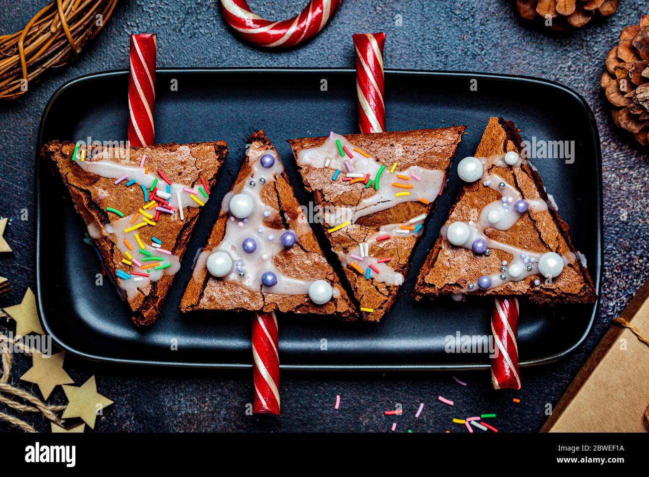 Weihnachtsbaum Brownies mit Zuckerrohr und Glasur, dunkler Hintergrund. Weihnachtsessen Konzept. Stockfoto