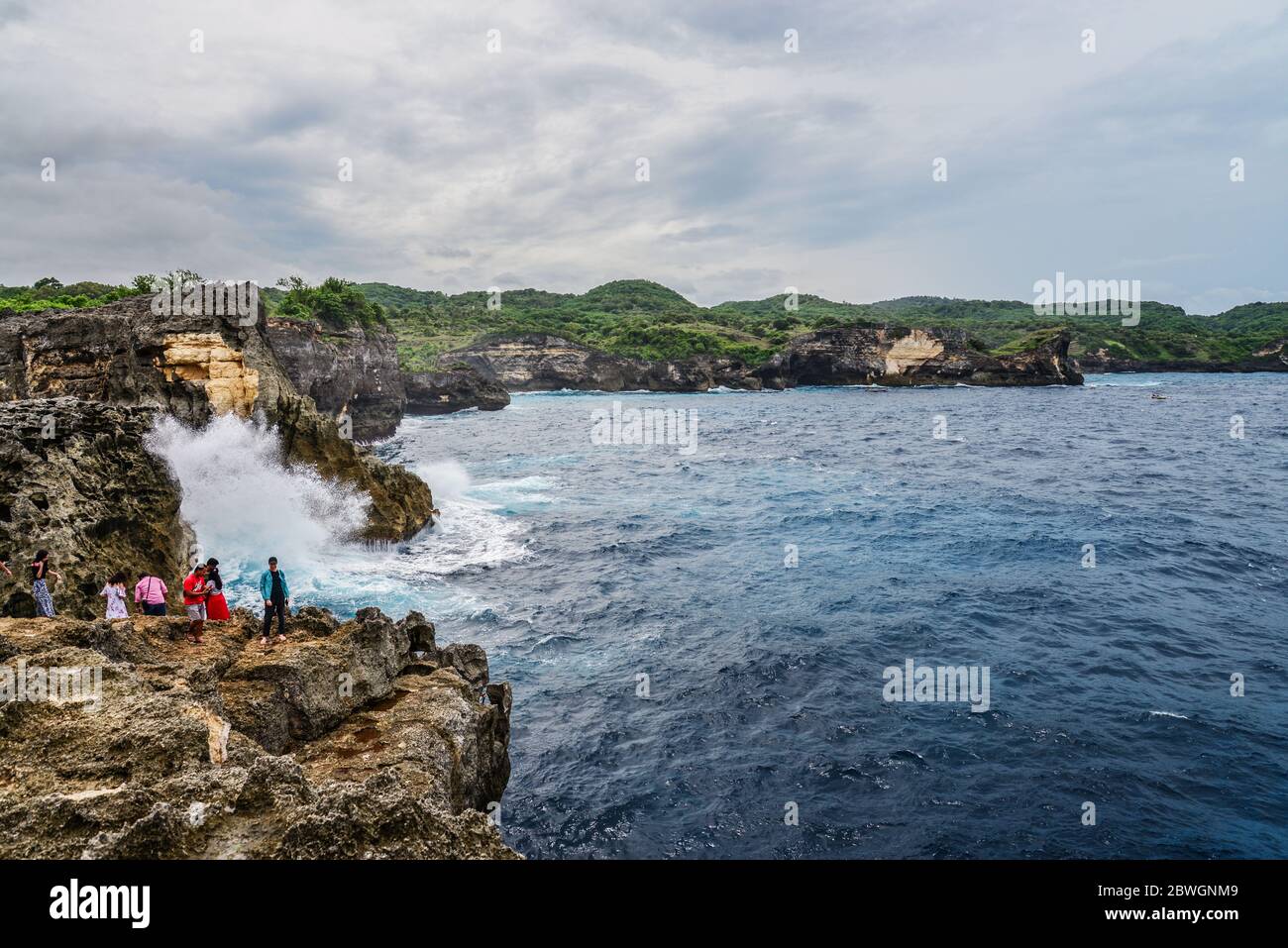 NUSA PENIDA, INDONESIEN - 22. JANUAR 2019: Küste auf der Insel Nusa Penida in der Nähe von Angel's Billabong Strand mit Touristen in Indonesien Stockfoto