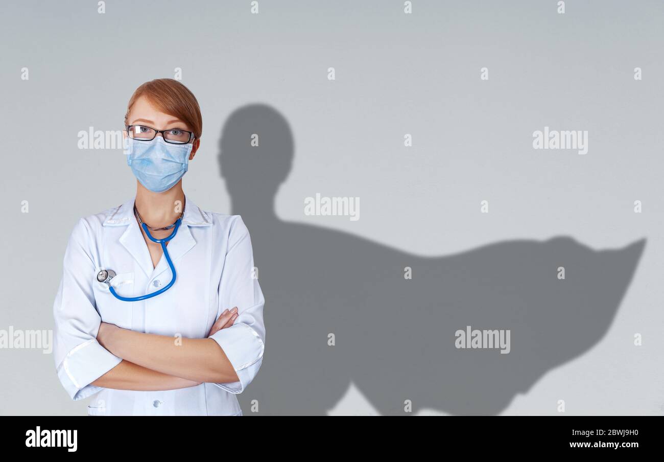 Konzept der tapferen Ärzte in Uniform und Maske mit Schatten flatternden Umhang hinter ihrer Schulter. Stockfoto