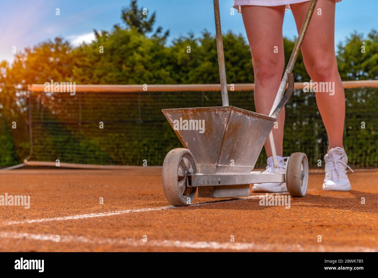 Wartung und Reparatur von Tennisplätzen. Zeichnung von weißen Linien mit Kalk Stockfoto