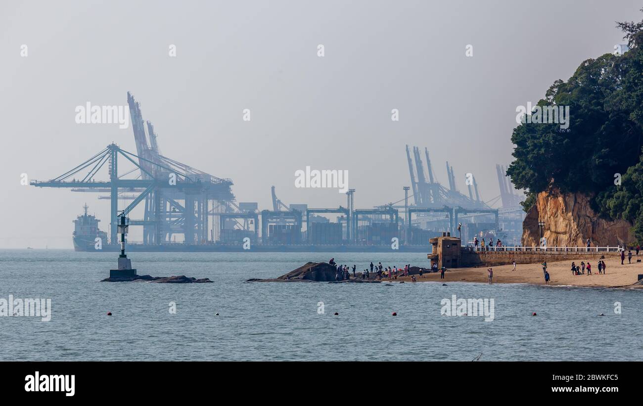 Blick auf den Hafen von Xiamen (Freihandelszone Haicang District) mit einem Schiff und Kräne. Symbol für internationalen Handel, Wirtschaft, Schifffahrt, Fracht. Stockfoto