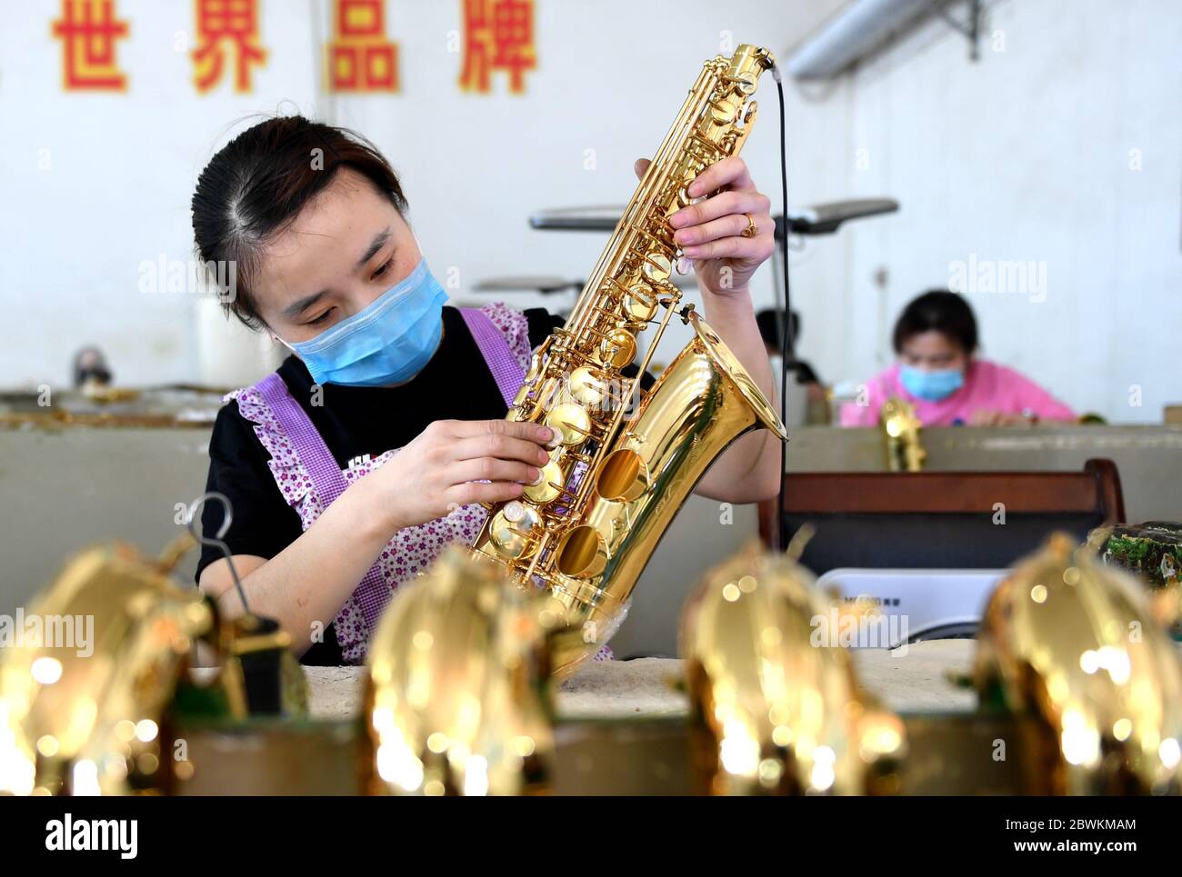 Hengshui, Chinas Provinz Hebei. Juni 2020. Ein Arbeiter montiert Saxophone in einer Musikinstrumentenfabrik im Wuqiang Bezirk von Hengshui, Nordchinesische Provinz Hebei, 2. Juni 2020. Die Behörden im Wuqiang County haben eine Initiative zur Armutsbekämpfung durchgeführt, die die lokale Musikinstrumentenindustrie dazu ermutigt, ländliche Bewohner, die unterhalb der aktuellen Armutsgrenze leben, einzustellen und ihnen dabei zu helfen, neue Karrieren zu beginnen. Kredit: Zhu Xudong/Xinhua/Alamy Live News Stockfoto
