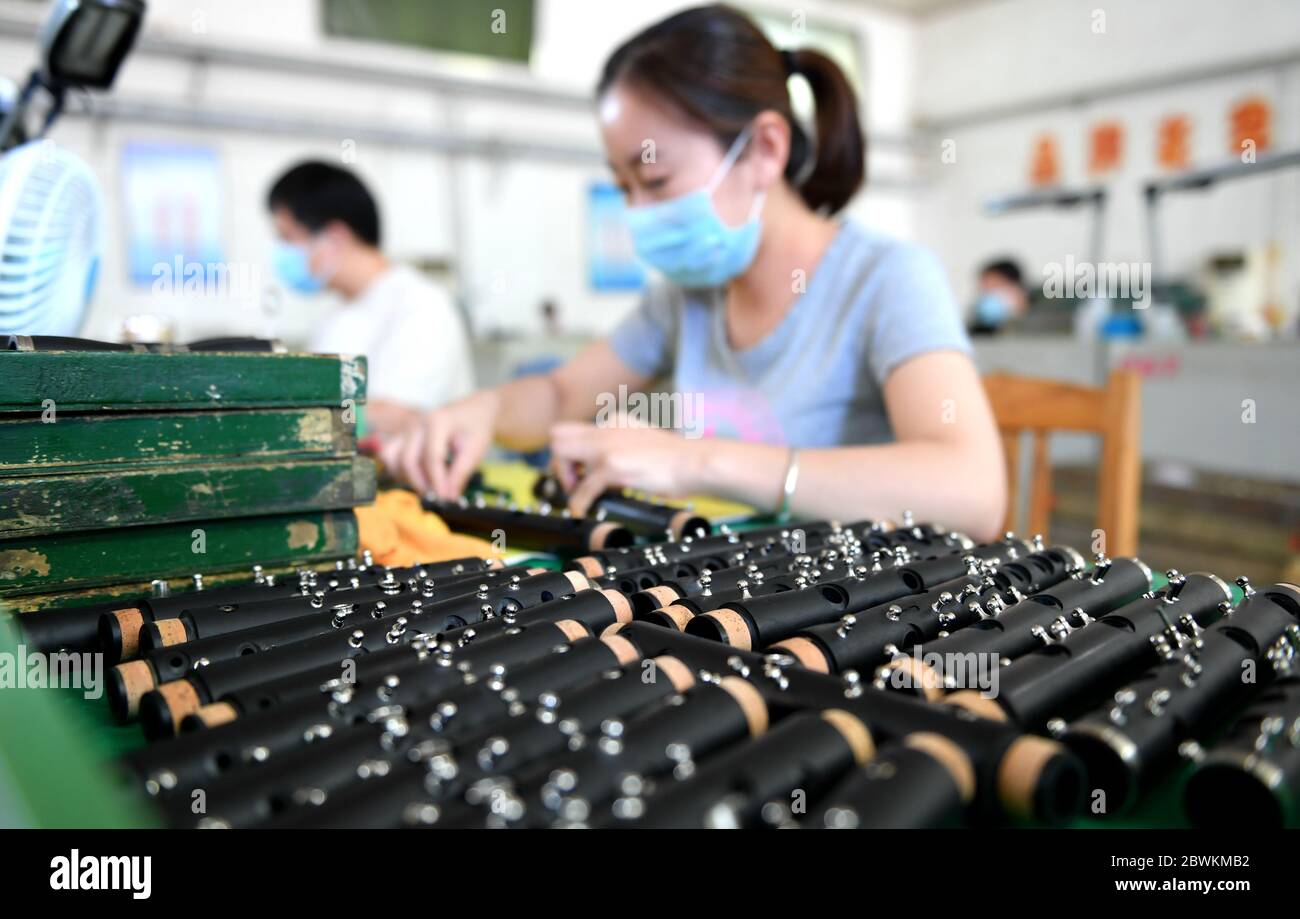 Hengshui, Chinas Provinz Hebei. Juni 2020. Menschen arbeiten in einer Musikinstrumentenfabrik im Wuqiang Bezirk von Hengshui, Nordchinesische Provinz Hebei, 2. Juni 2020. Die Behörden im Wuqiang County haben eine Initiative zur Armutsbekämpfung durchgeführt, die die lokale Musikinstrumentenindustrie dazu ermutigt, ländliche Bewohner, die unterhalb der aktuellen Armutsgrenze leben, einzustellen und ihnen dabei zu helfen, neue Karrieren zu beginnen. Kredit: Zhu Xudong/Xinhua/Alamy Live News Stockfoto
