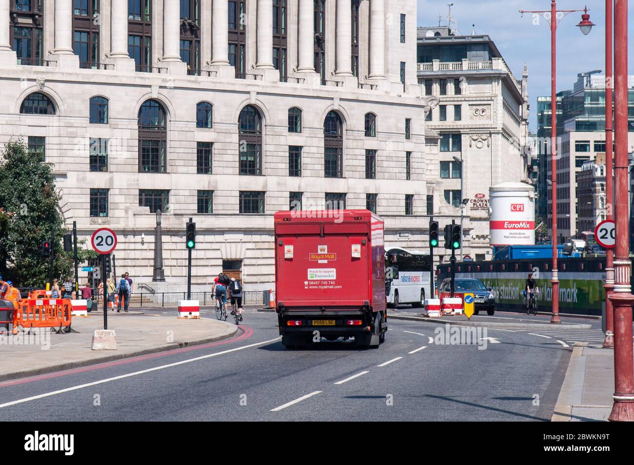London, England, Großbritannien - 30. Juli 2011: Radfahrer und Autoverkehr passieren die Kreuzung von Blackfriars Bridge und Queen Victoria Street während der Fahrzeit Stockfoto