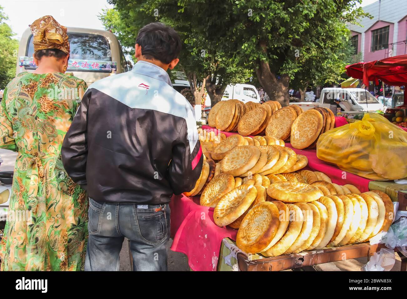 Yining, Xinjiang, China - 13. Juli 2014: Uigurisches Fladenbrot wird an einem Marktstand unter freiem Himmel verkauft Stockfoto