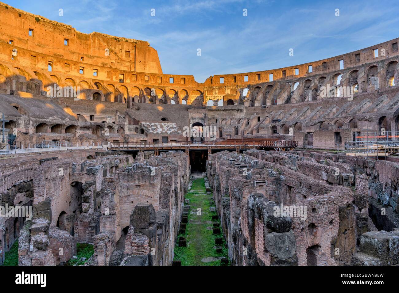 Innenraum des Kolosseums - BLICK auf den Sonnenuntergang über der Arena und Hypogeum umgeben von alten hohen Mauern im Inneren des Kolosseums. Rom, Italien. Stockfoto
