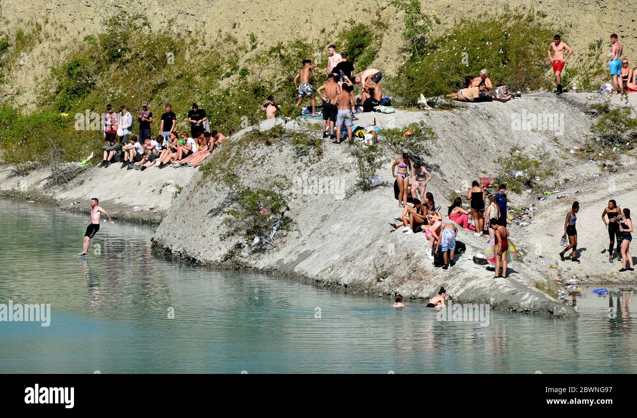 Shadwell Quarry, Love Wenlock, Shropshire. Juni 2020. Hunderte von jungen Menschen und ihre Familien, die während der Pandemie in der „Blauen Lagune“, einem stillgelegten Kalksteinbruch in der Nähe von Much Wenlock, baden und schwimmen. Die Polizei hat eine Sicherheitswarnung ausgegeben, nachdem zwei Menschen letzte Woche aus dem stillgelegten Shropshire-Steinbruch gerettet wurden, aber sie waren noch heute in Schwärme. Stockfoto