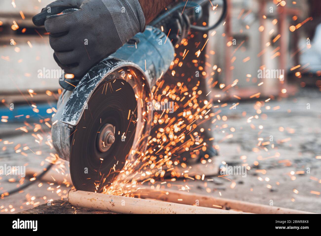 Bauarbeiter mit Winkelschleifer Schneiden von Metall auf der Baustelle. Stockfoto