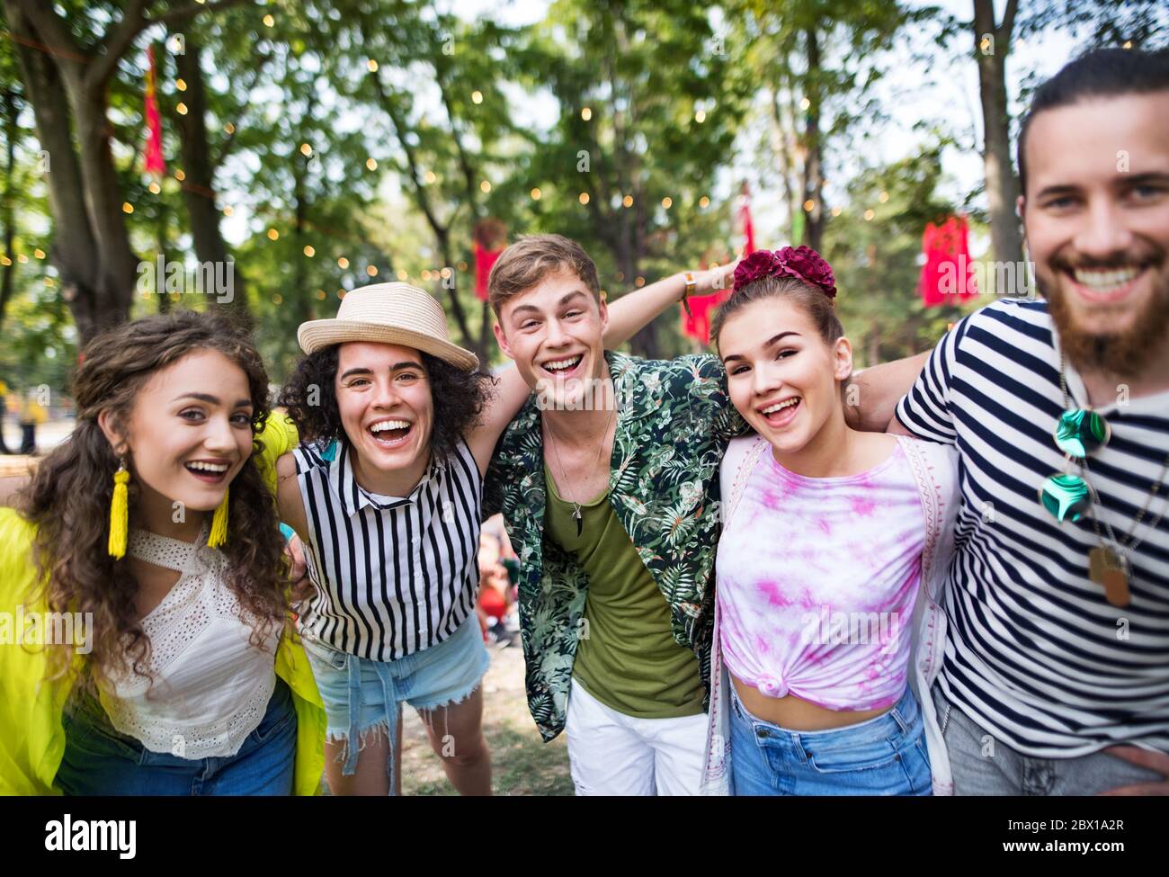 Gruppe von jungen Freunden auf dem Sommerfest, die Kamera betrachten. Stockfoto